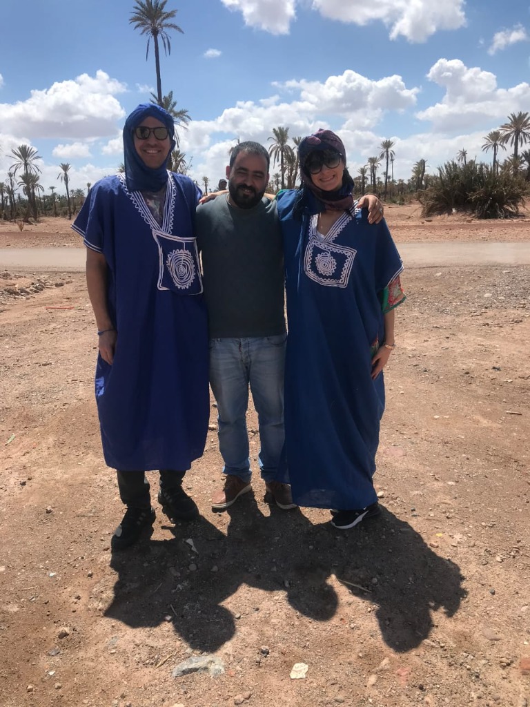 Couple in blue robes posing with driver
