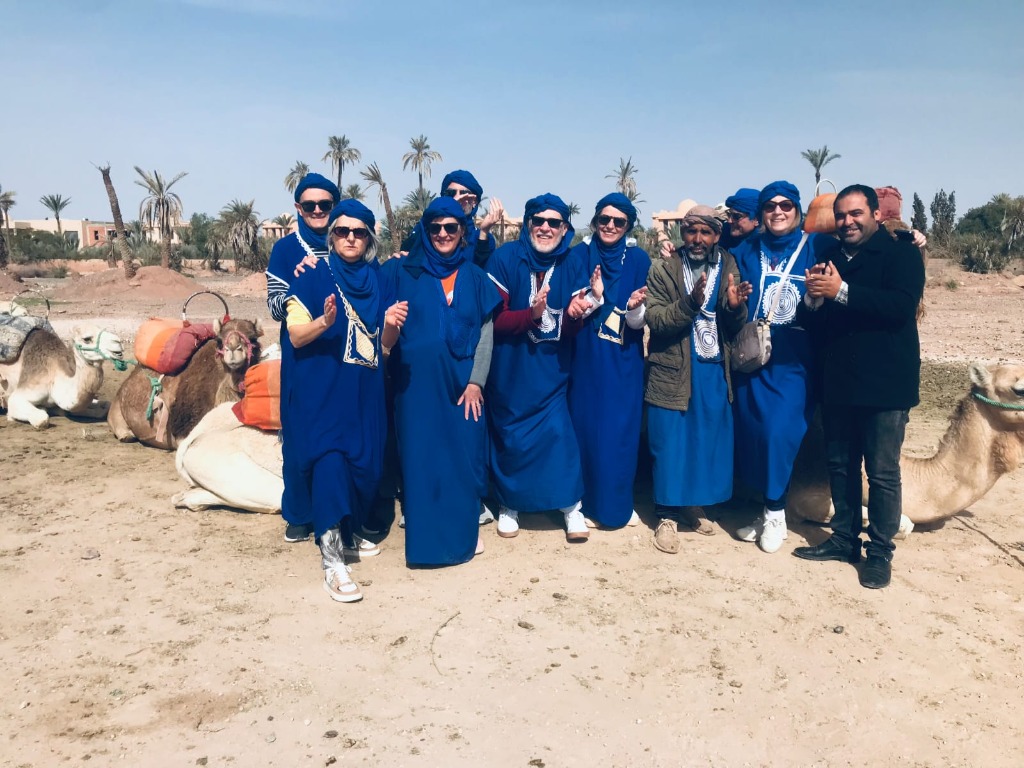 Group with camels in desert