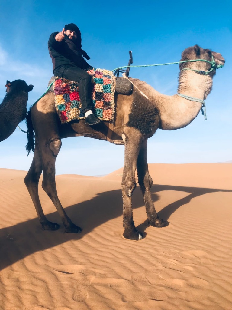 Riding a camel in Sahara